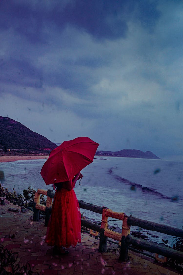 Photo Of Person Wearing Red Dress While Holding Red Umbrella