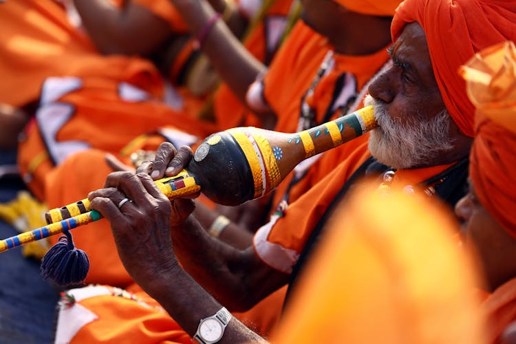 Close-Up Photo Of Man Playing Wind Instrument