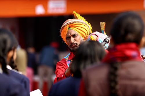 Free Vibrant scene of performers in traditional attire during an Indian festival parade outdoors. Stock Photo