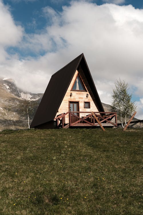 A small cabin sits on top of a hill