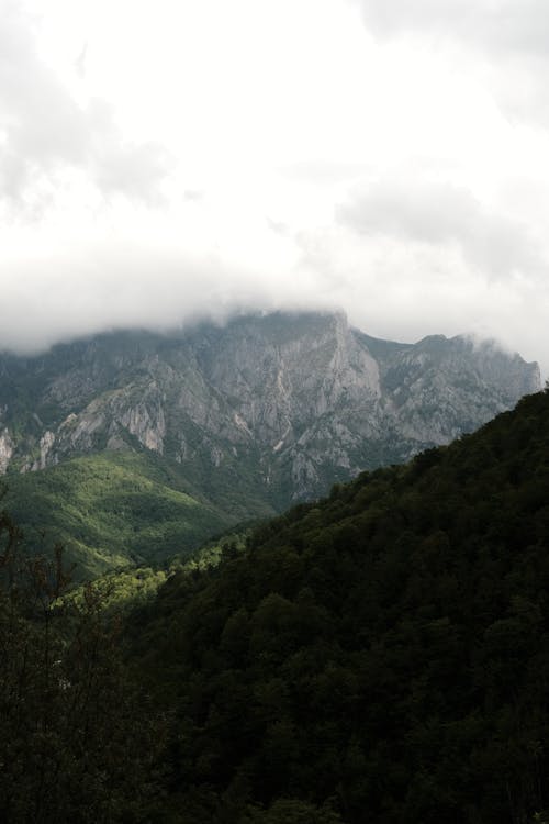 A view of a mountain range with clouds