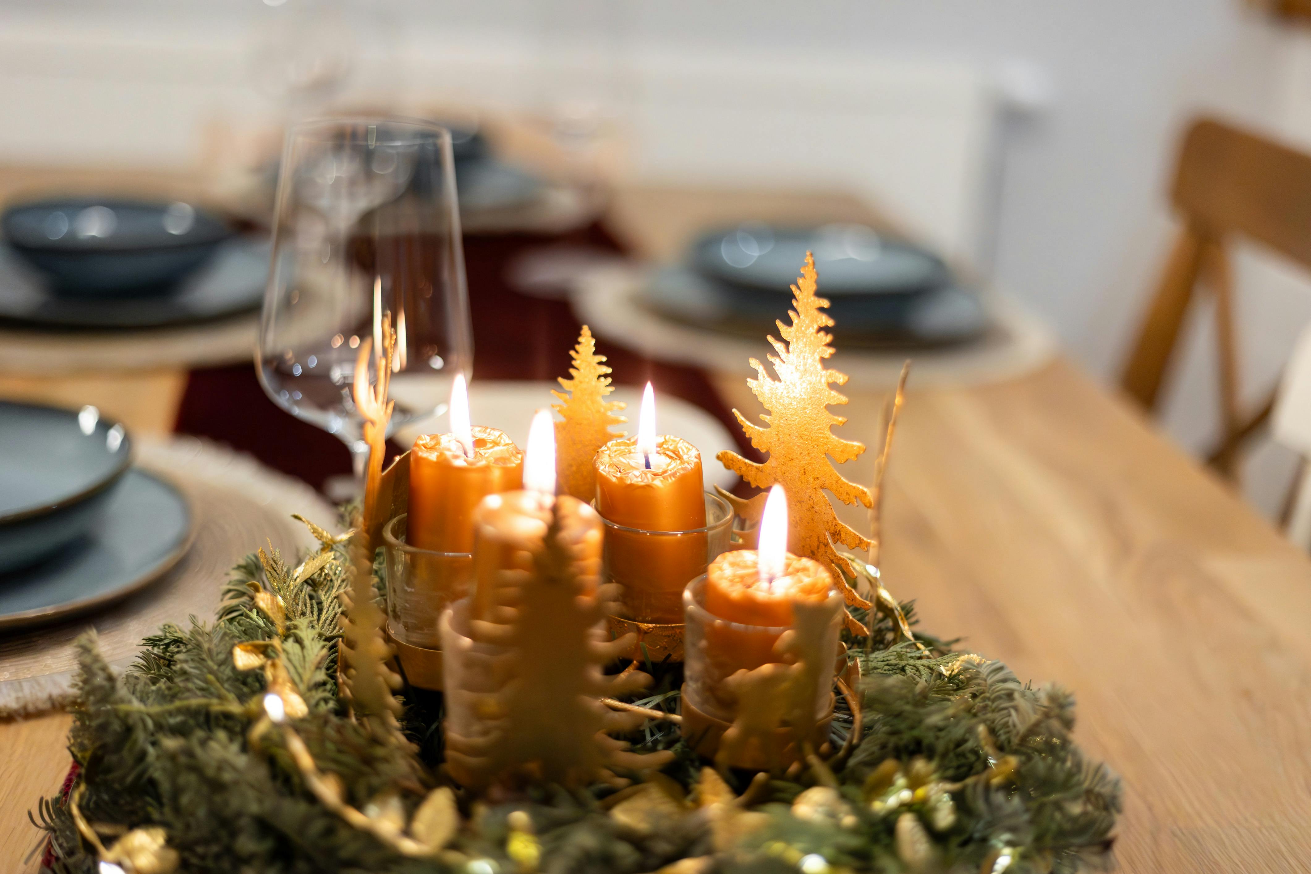 close up of a christmas decoration with candles standing on the table