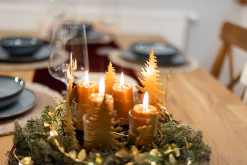 Free Beautiful Christmas-themed table setting featuring a festive candle centerpiece. Stock Photo