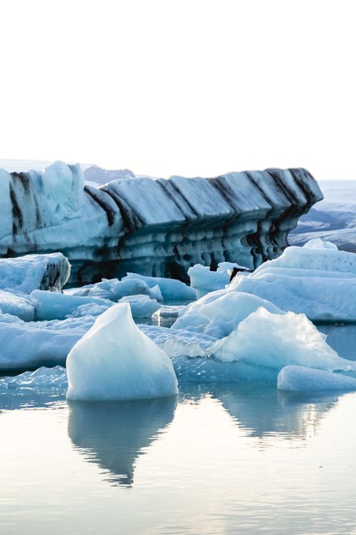 Free Magnificent icy landscape featuring stunning icebergs floating in clear water, reflecting a serene winter ambiance. Stock Photo