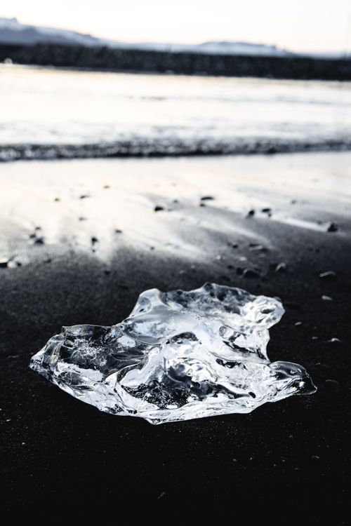 Free Close-up of ice on a dark beach capturing cold elegance during winter. Stock Photo