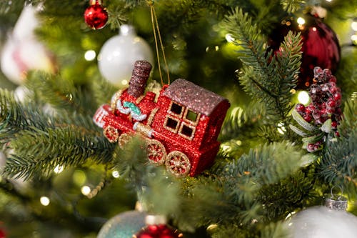 A christmas tree with ornaments and a train
