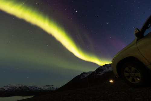 A car parked under the aurora lights