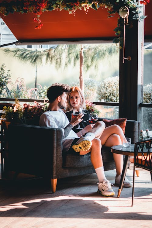 A couple sitting on a couch in a restaurant