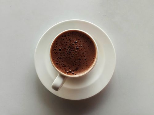 Free A top-down view of espresso coffee with rich foam in a white cup on a saucer. Stock Photo