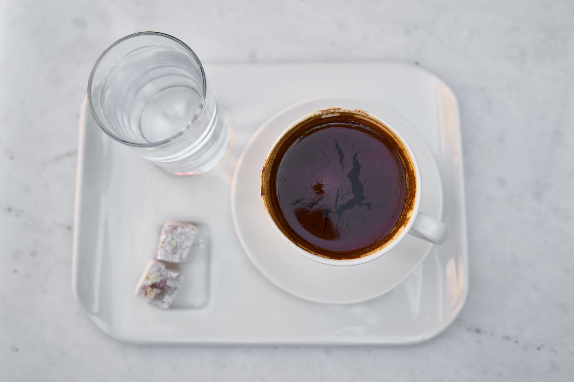 White Ceramic Mug on White Saucer Full With Brown Liquid