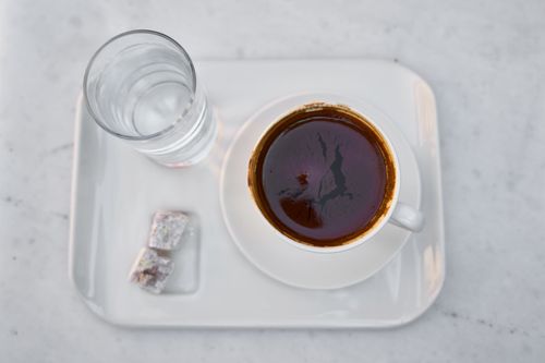 Free A cup of Turkish coffee served with Turkish delight and water on a tray. Stock Photo