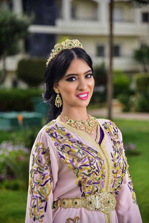 Free Fashion portrait of a woman in an embellished dress with jewelry in an outdoor setting. Stock Photo