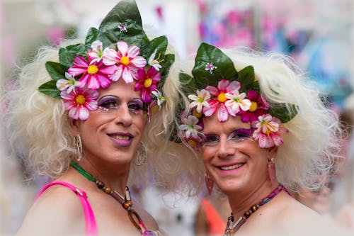 People Wearing Floral Headbands and Smiling