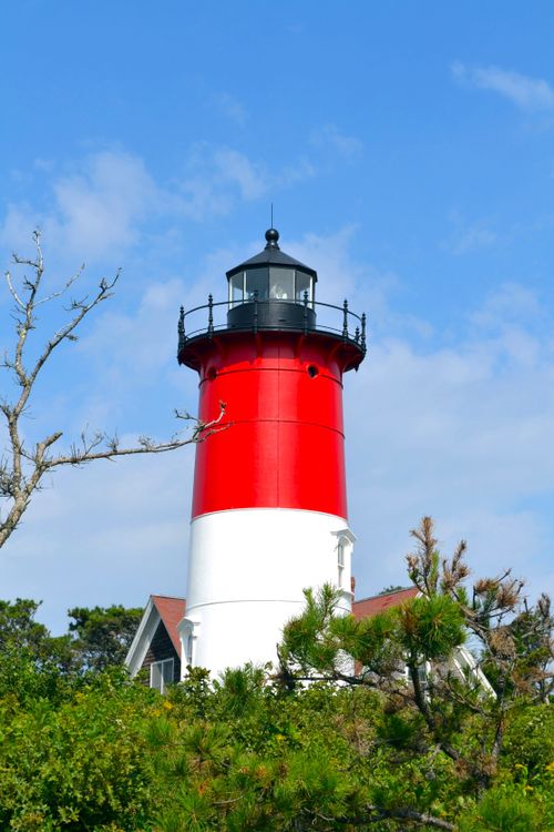 Free Red and white Nauset Lighthouse against a bright blue sky in Eastham, Massachusetts. Stock Photo