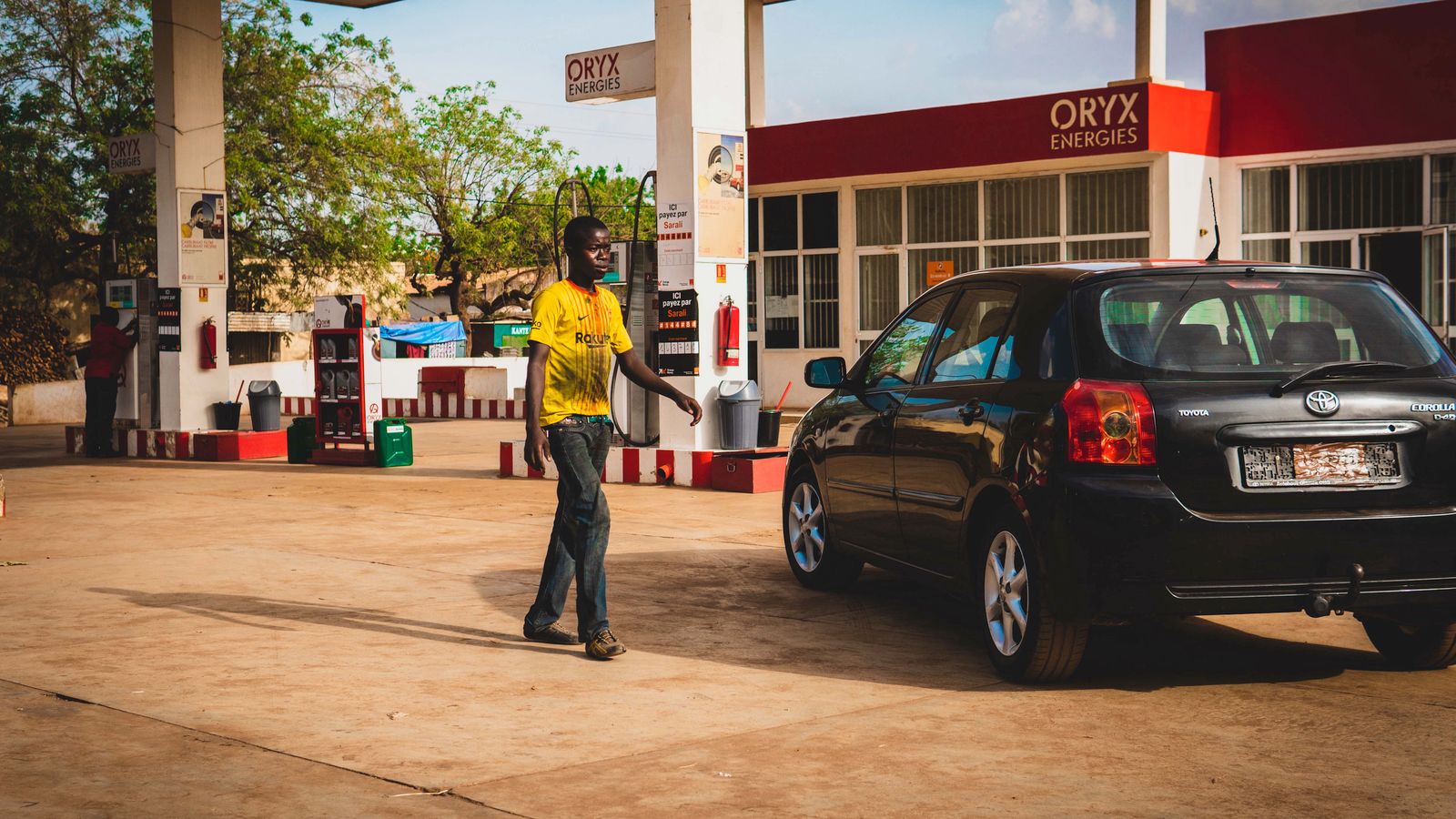 Man walking near car, Burkina Faso