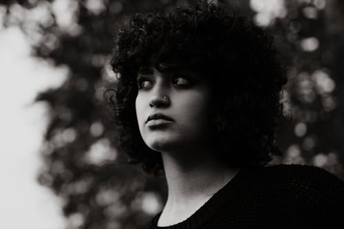 A woman with curly hair and a black sweater