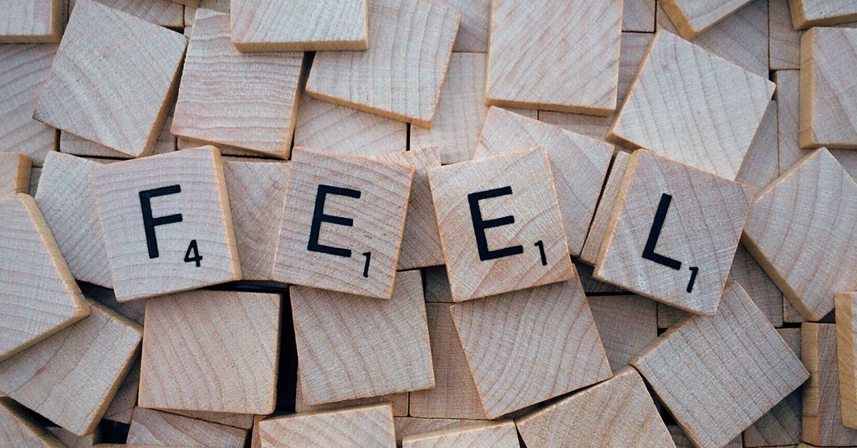 Close-up of Scrabble tiles spelling 'Feel' scattered on a wooden background. - Evidence evidence guide for l-theanine cognitive performance randomized trial