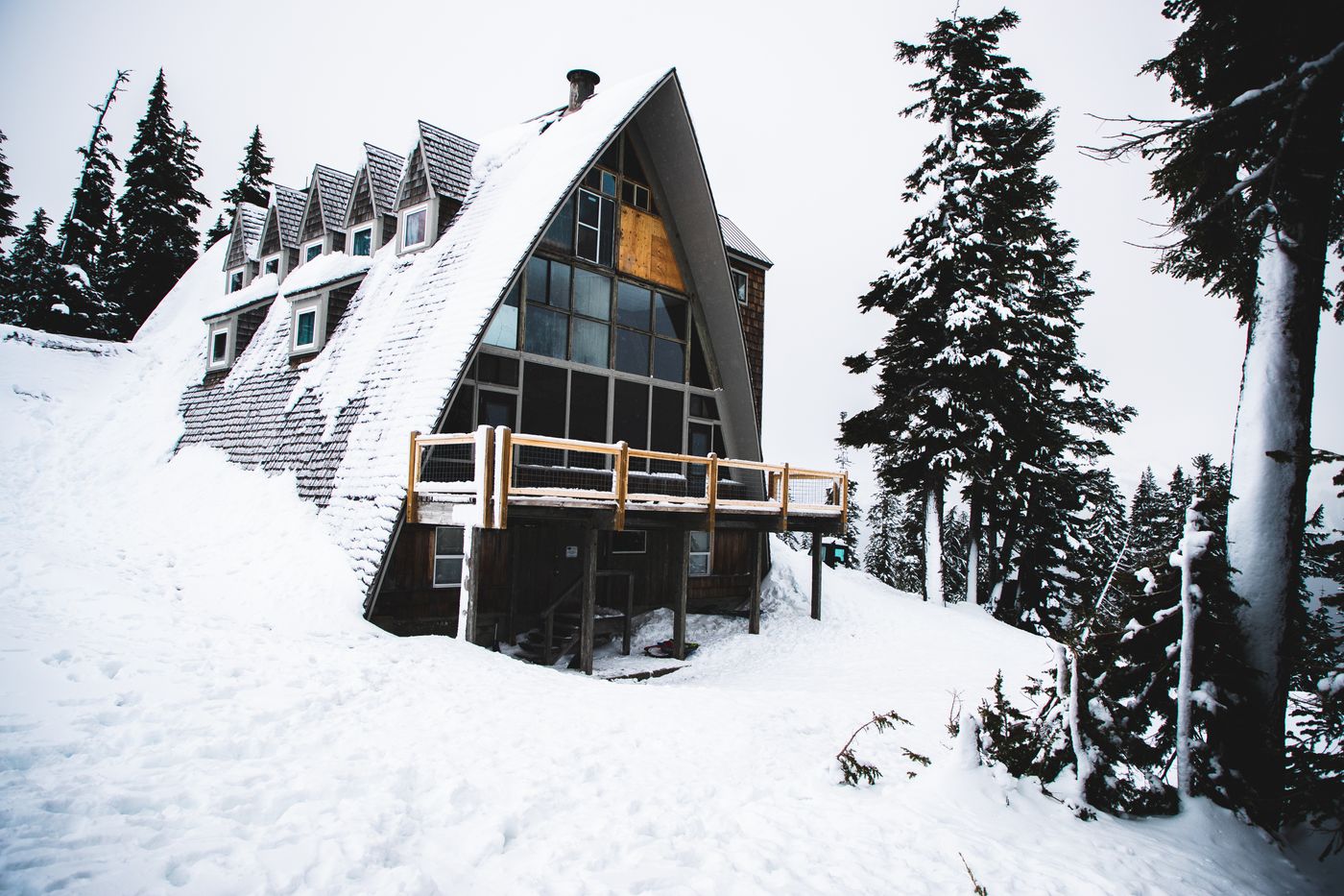 A-frame cabin surrounded by snowy trees