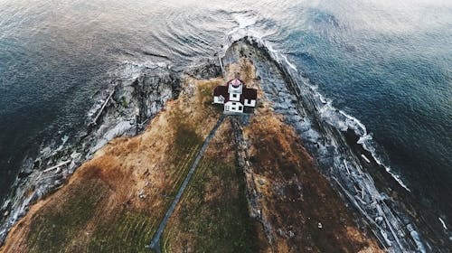 Aerial View of House Beside Body of Water