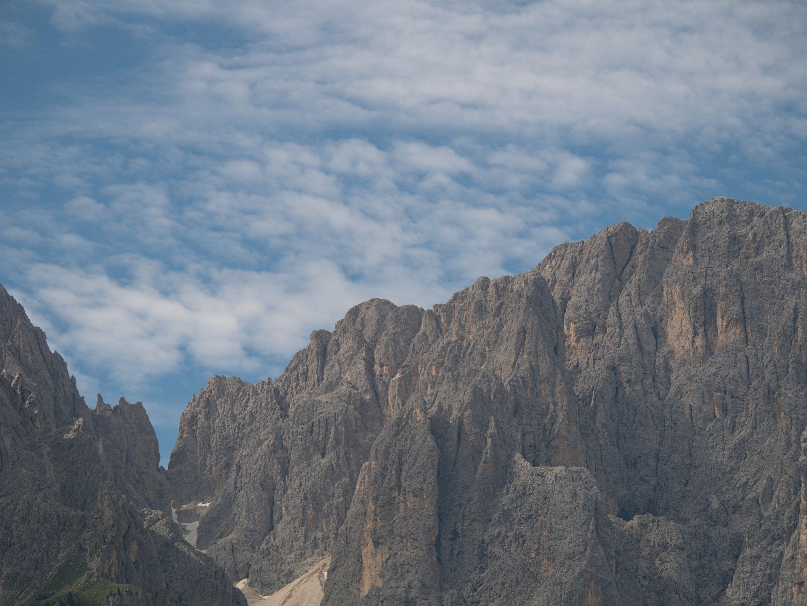 A mountain range with a blue sky and clouds · Free Stock Photo