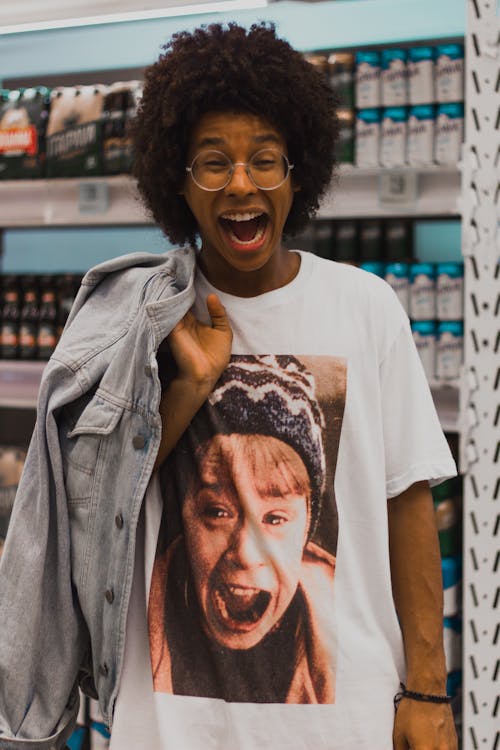 Photo of a man standing in a supermarket with mouth open