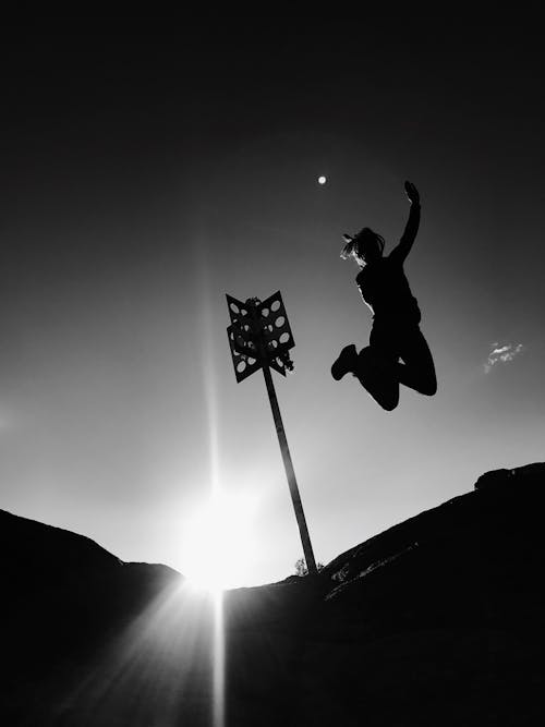 Grayscale Photo Of Person Jumping 