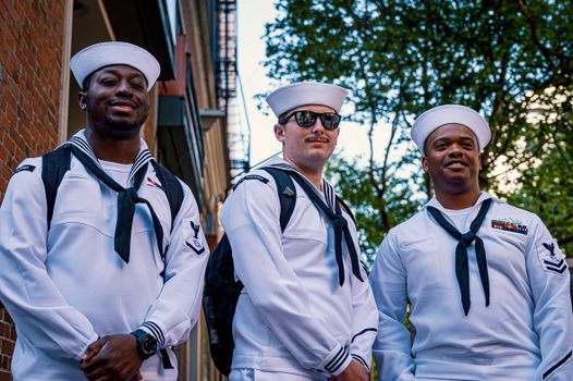 Three Men Standing in White Uniform and Smiling
