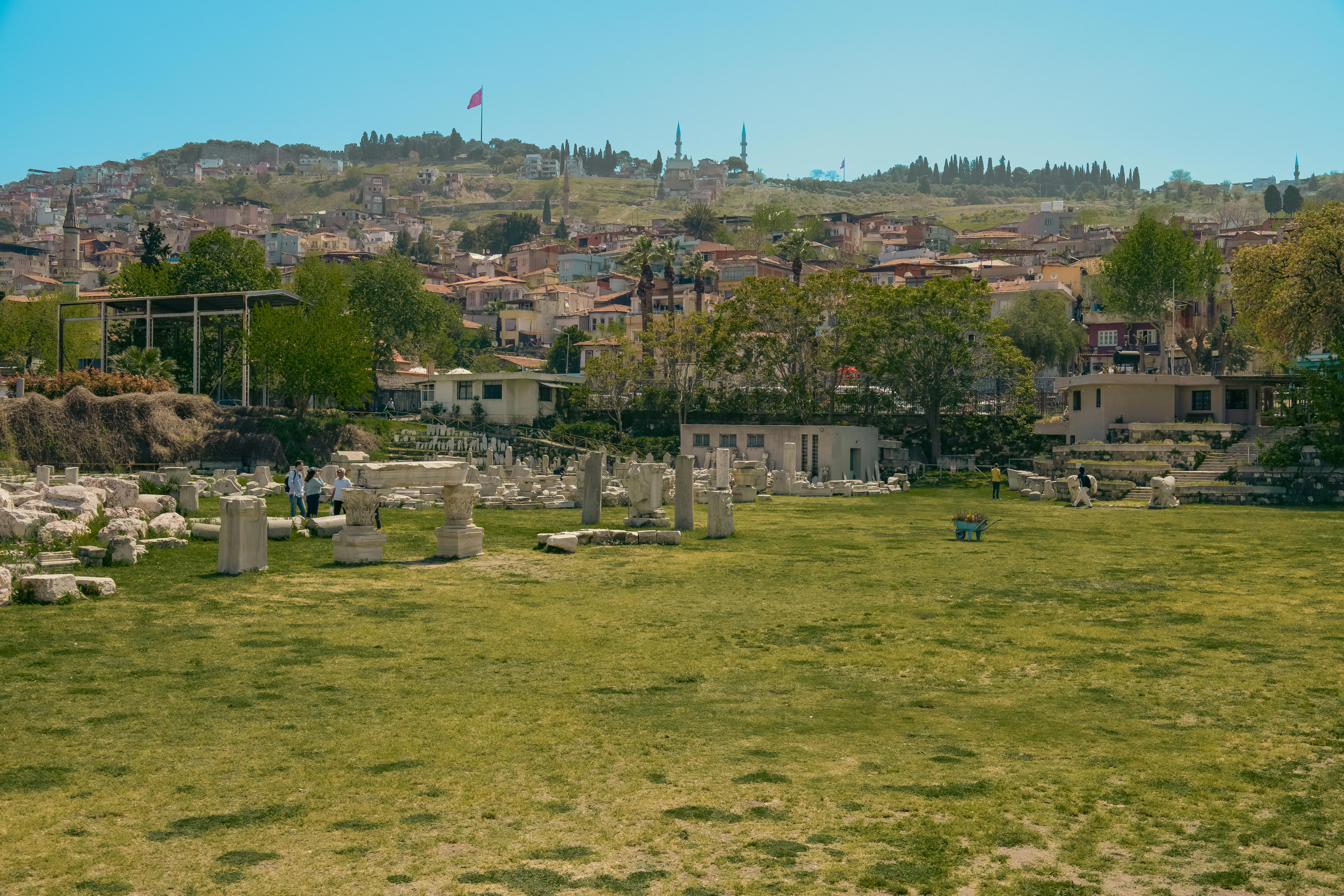 landscape of ancient stones on a lawn in front of a view on a small town