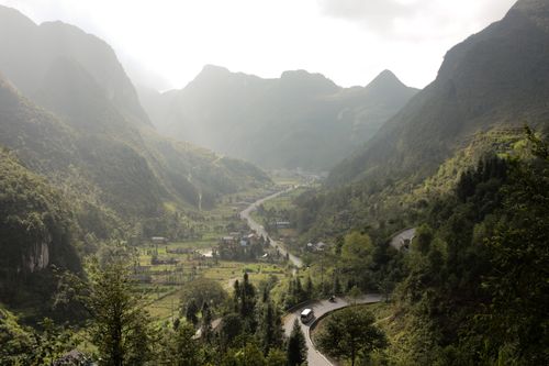 Free A breathtaking view of winding roads through verdant hills and mountains in Hà Giang, Vietnam. Stock Photo