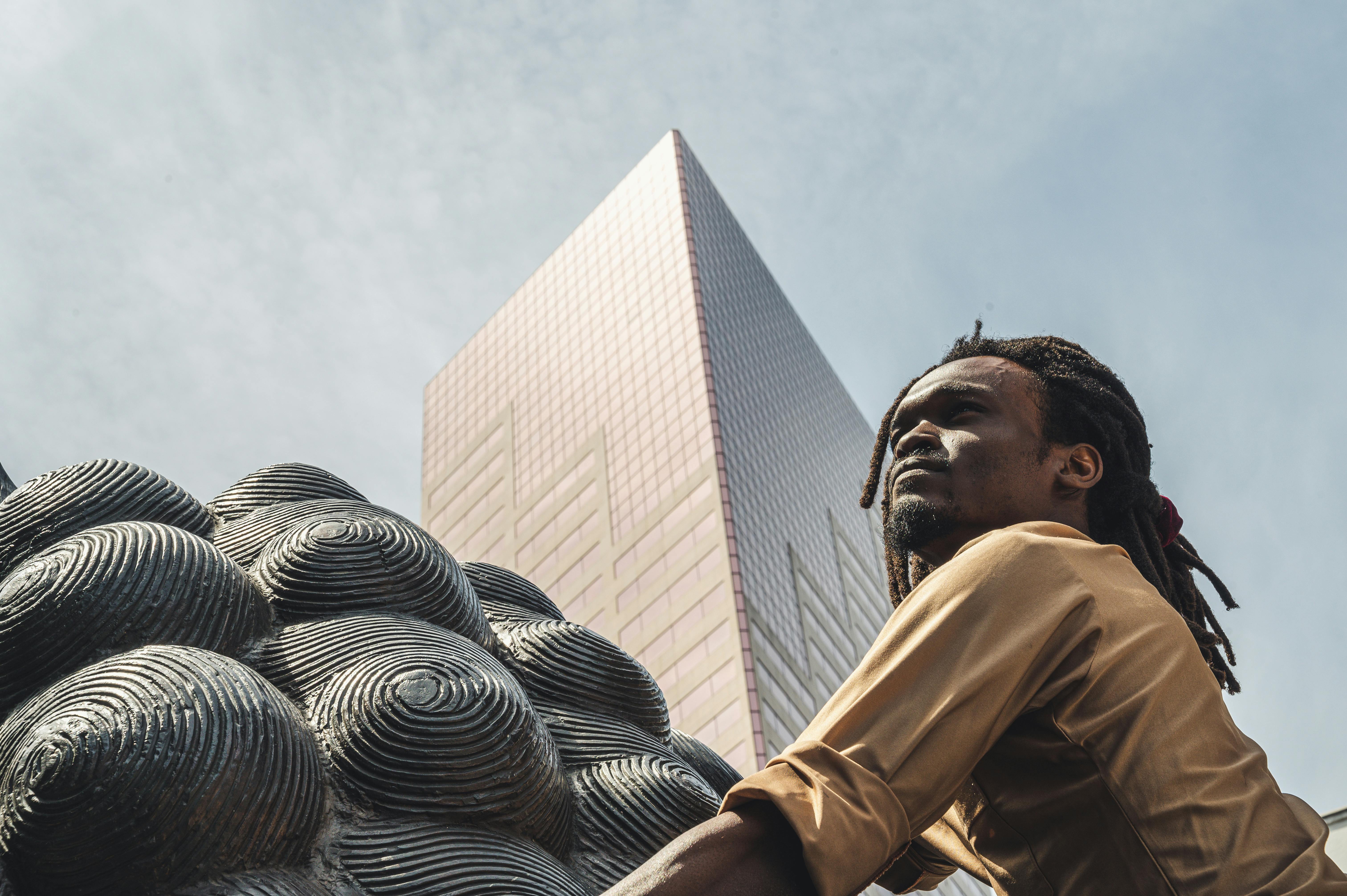 Man Wearing Brown Dress Shirt Near Building