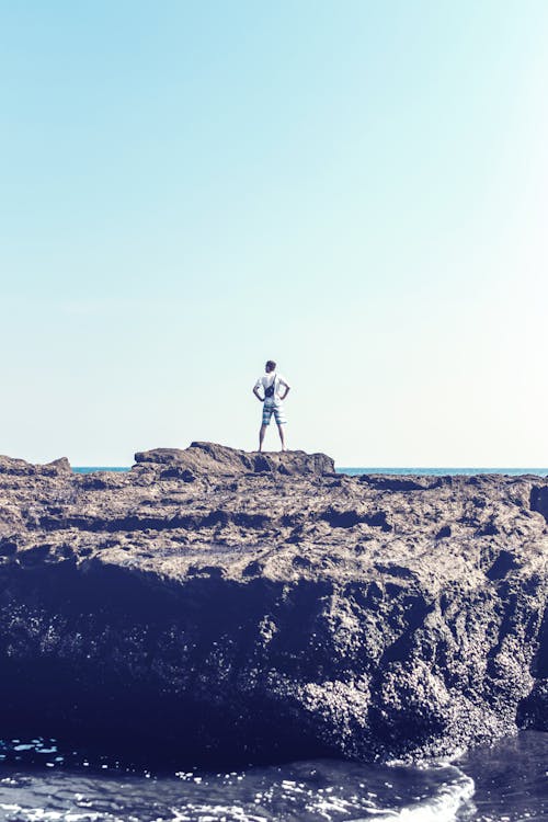 Free Man Standing on Grey Rock Stock Photo