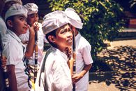 Four Boys Wearing White Hats Holding Spears