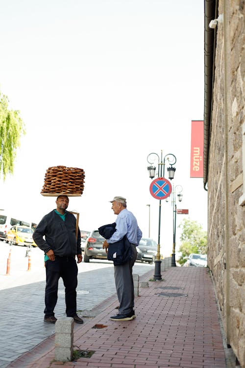 A man carrying a tray of bread on his head