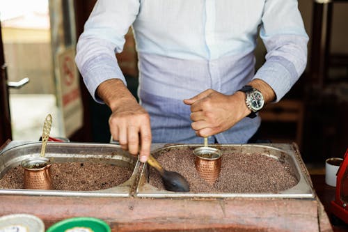 A man is making coffee in a coffee shop