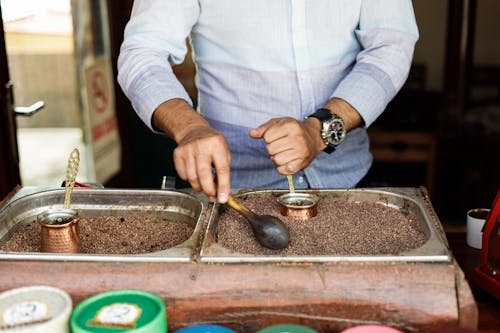 A man is making coffee in a coffee shop