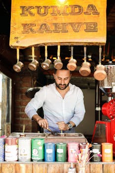 Man preparing Turkish coffee in a traditional setting with various colorful coffee tins.