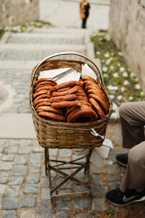 A basket of donuts on a cobblestone street