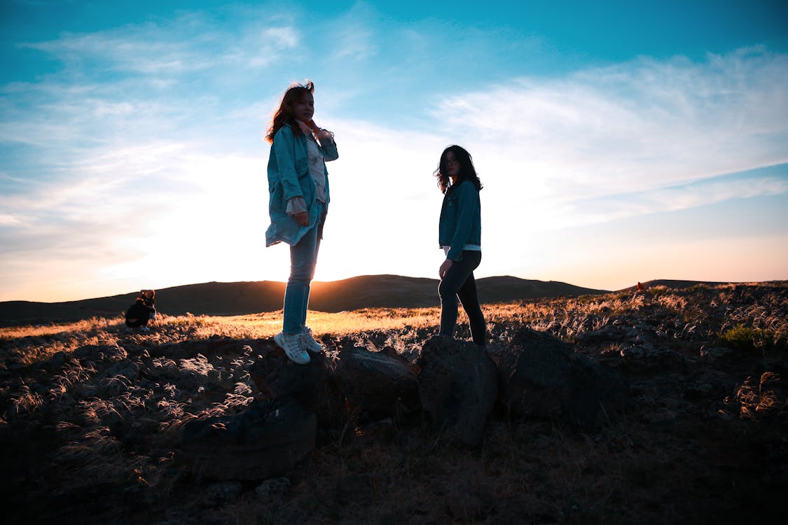 Two Women Standing on Rocks