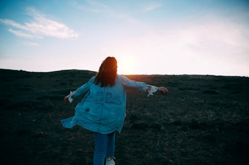 Woman Opening Her Hands during Golden Hour