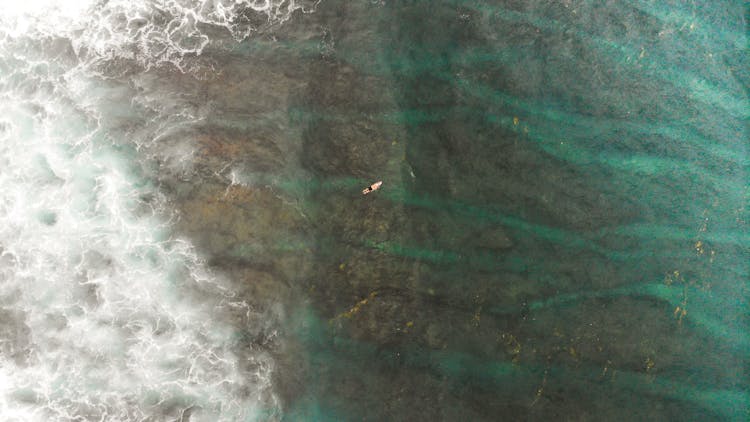 Person On Surfboard Waiting For Big Waves