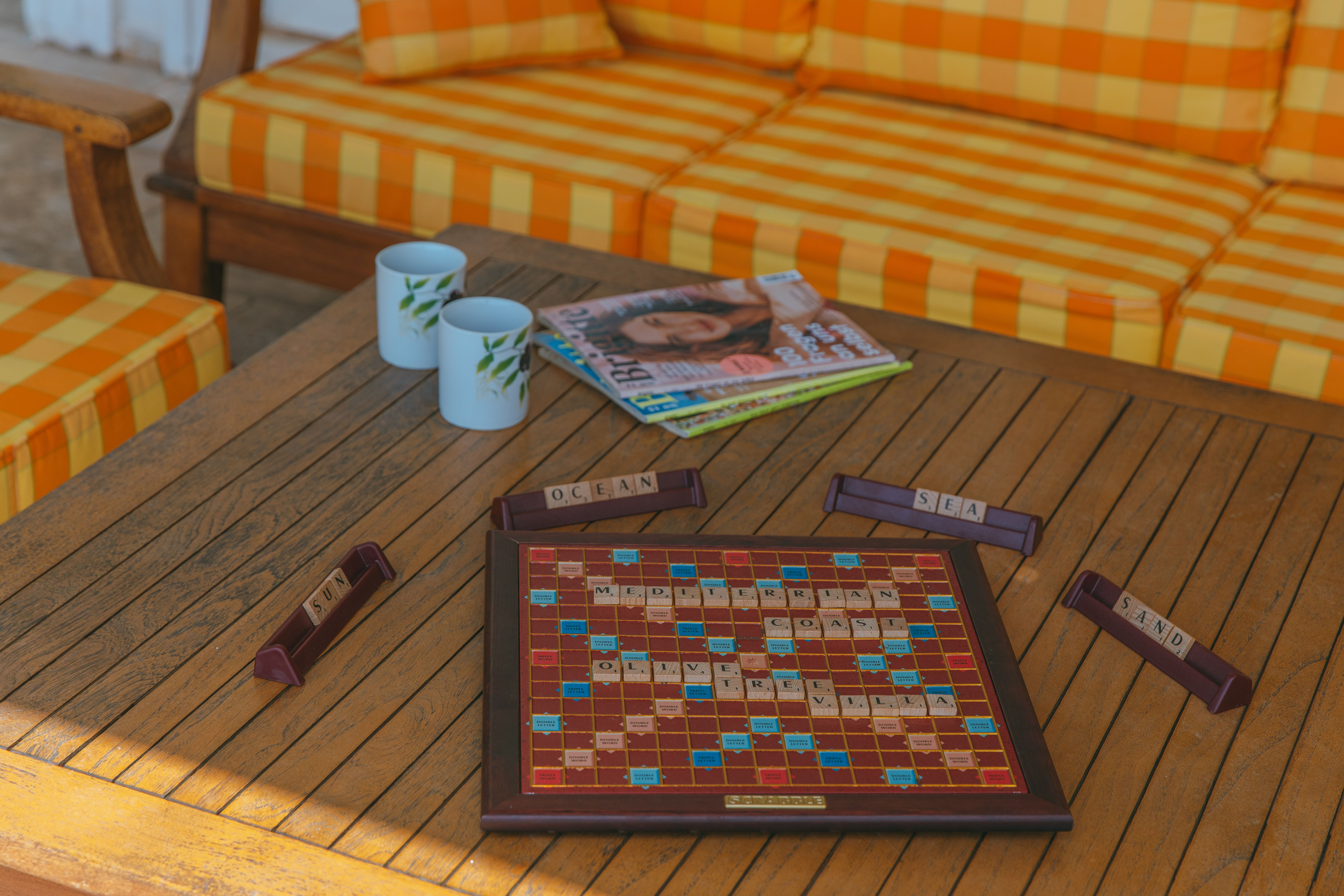 A Word Game Lying on the Table on a Terrace · Free Stock Photo