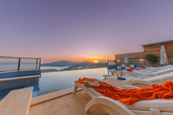 Pool loungers at sunset