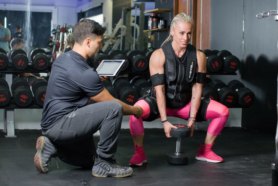 person doing dumbbell goblet squat in gym person doing dumbbell goblet squat in gym