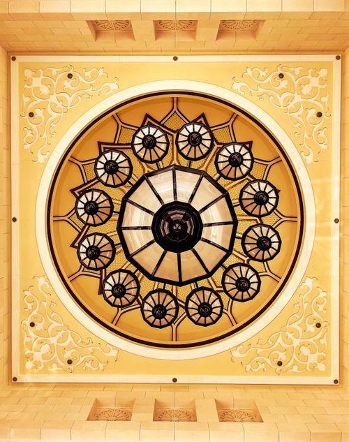 Free Intricate ceiling chandelier with ornate rosette and symmetrical design. Stock Photo