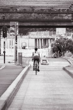 A woman cycling on an urban street, showcasing an active lifestyle in a city setting.