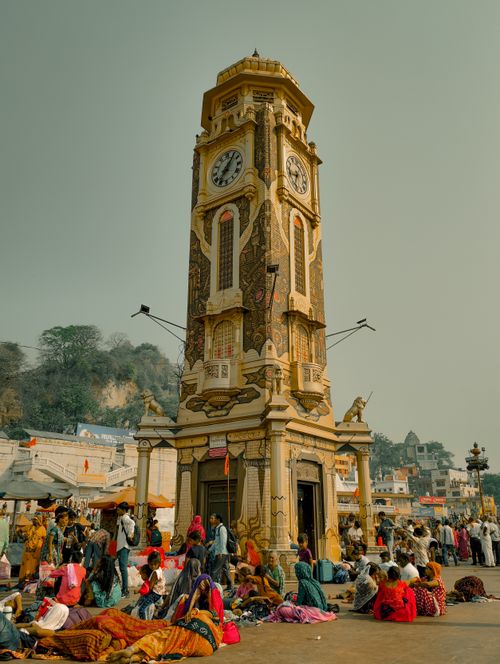 Free Clock tower in Haridwar bustling with people, showcasing vibrant street life of India. Stock Photo