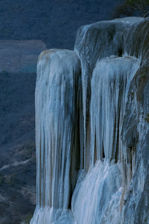 A waterfall with icicles hanging from it