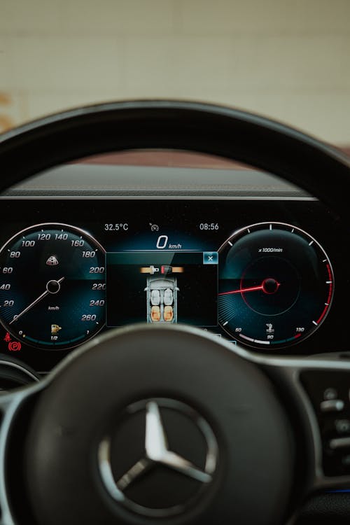 The dashboard of a mercedes car with gauges and a speedometer