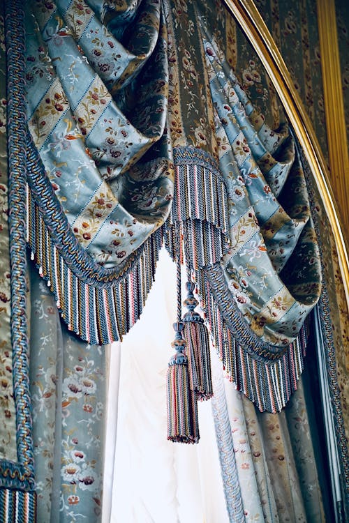 A window with a curtain and tassel hanging from it