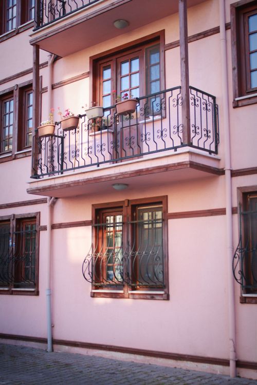 A pink building with balconies and balconies · Free Stock Photo